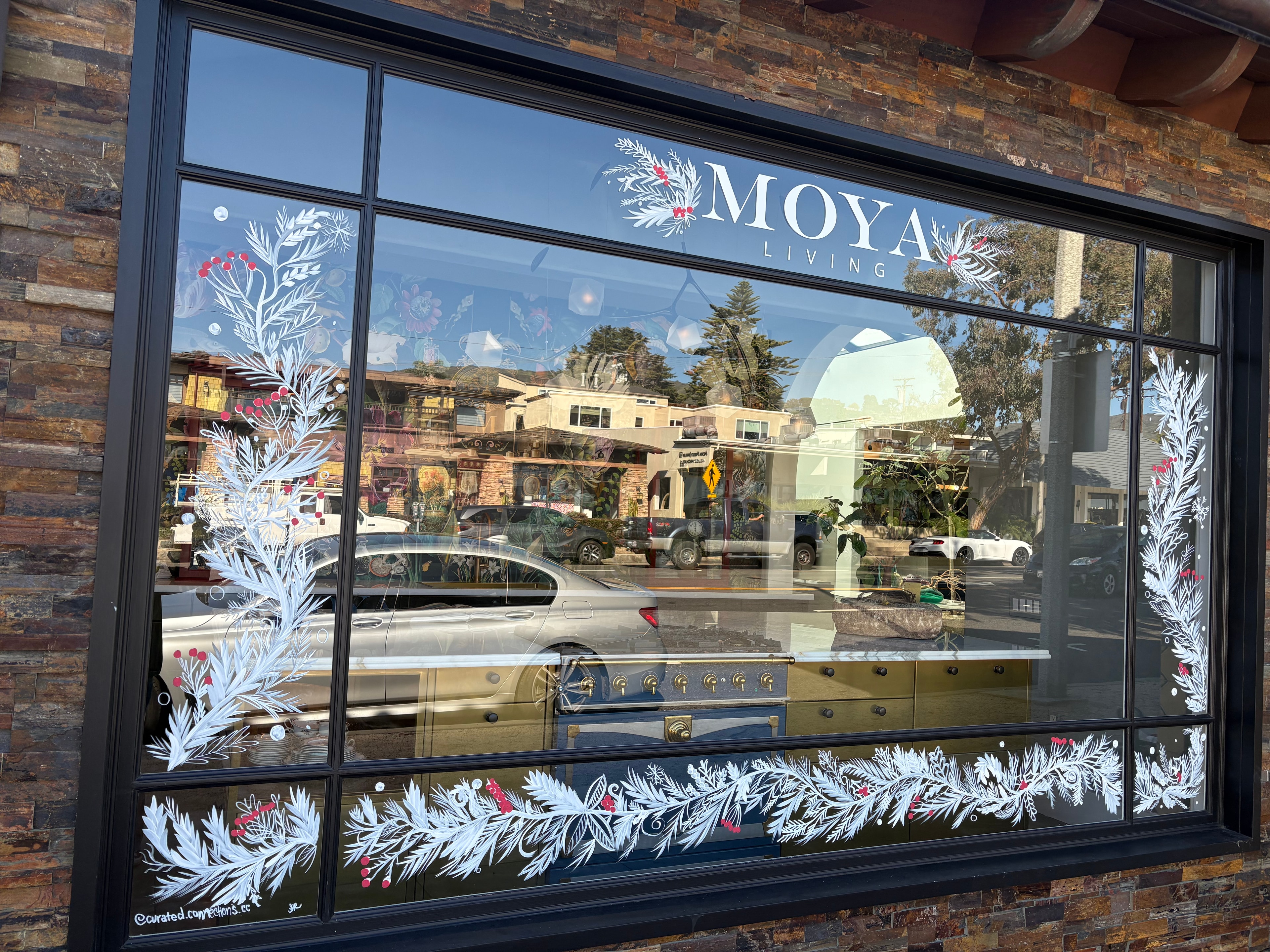 Sub-Zero Wolf holiday window — full view with garland border