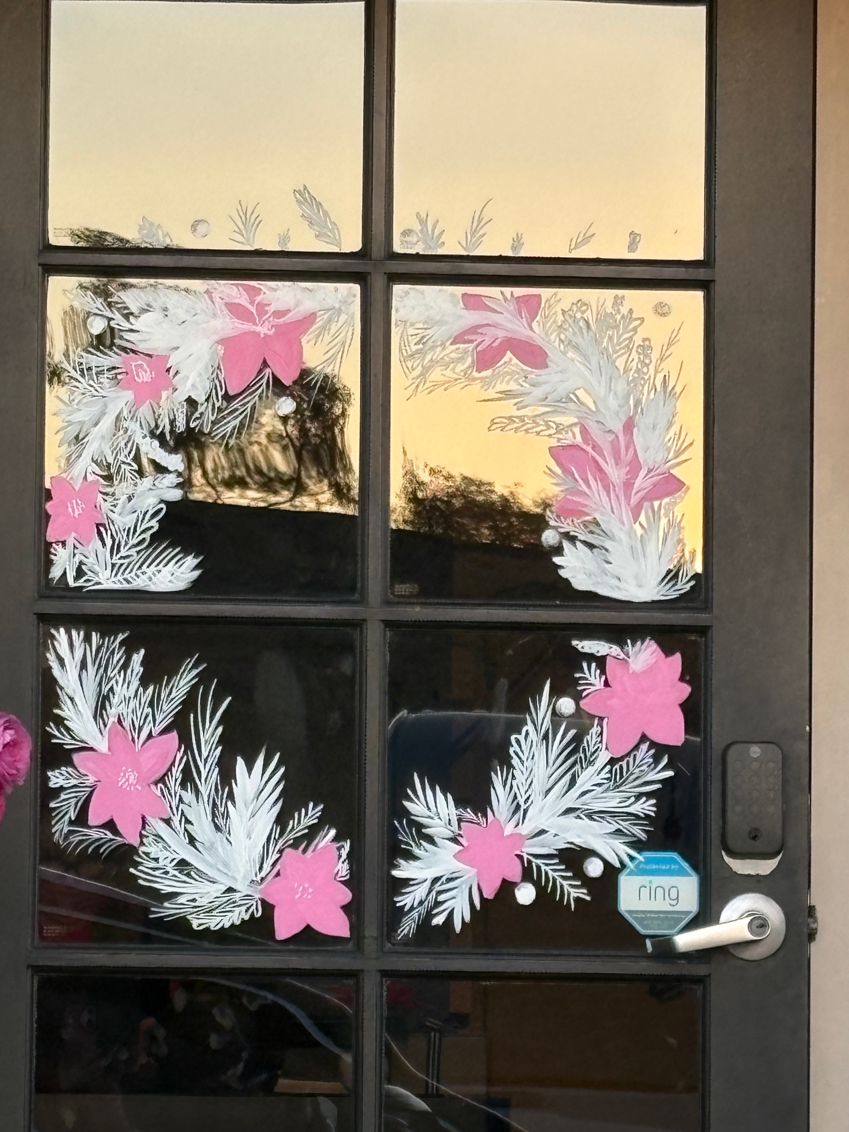 Holiday window painting — pink flowers and white evergreen foliage